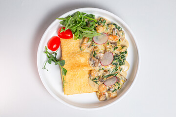 Top view Savory crepe with creamy mushroom sauce and fresh greens on a white plate
