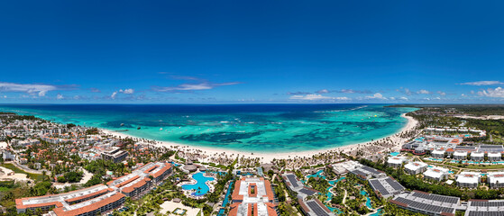 Aerial panorama of the large tropical beach with white sand and turquoise water of the Caribbean...