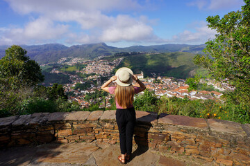 Holidays in Ouro Preto, Brazil. Full length of young traveler woman enjoying lookout of Ouro Preto historical city UNESCO world heritage site in Minas Gerais state, Brazil.