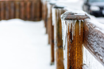 Icicle on a wood fence pole