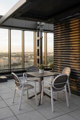 Vertical shot of roof top cafe in high rise architecture building with cityscape view