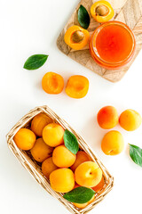 Friut background with apricot jam on white background top view
