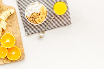 food for healthy breakfast with granola and fresh orange juice on bright white background top view mock up