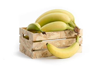 natural looking ripe yellow  bananas in a wooden crate and one falling out isolated on white