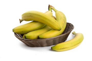 a bunch of natural looking ripe yellow  bananas in a wicker basket isolated on white