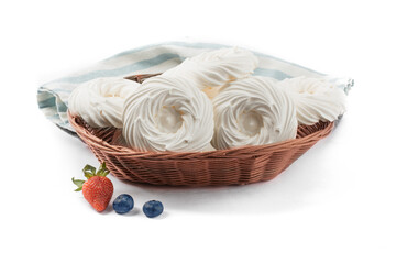 a basket of white meringue nests isolated on white