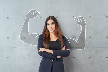  Happy young middle east business woman posing isolated over grey wall background.