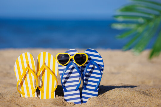 Flip-flops and sunglasses on the sand. Summer vacation concept