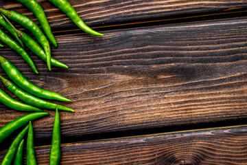 hot chilli pepper pattern on wooden background top view mock up