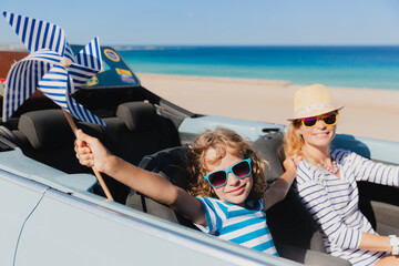 Happy family travels by car on summer vacation