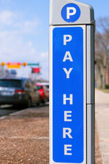 pay here signs for parking, kiosks for paying your car parking lot online with a credit card