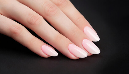 Fototapeta premium hand with natural nude manicure on black background close up