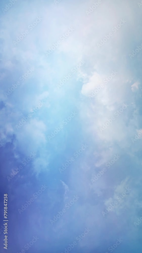 Wall mural vertical blue skies rising clouds 4k loop features a blue sky with moving cloud formations in a vert