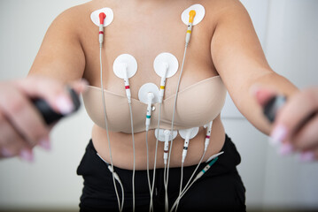 Obese woman undergoing a detailed cardiovascular fitness assessment in a modern clinic