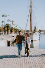 Serene stroll along Barcelona marina at with vintage sailing vessel