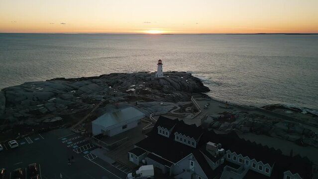 Peggy's Cove Lighthouse at dusk Canada. From its rocky perch overlooking the swirling ocean waves, lighthouse exudes a timeless elegance that captures the essence of Nova Scotia's maritime heritage.