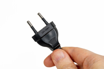 Electric plug being held in a hand
