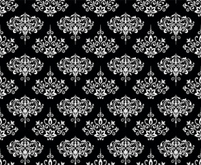 Wallpaper in the style of Baroque. Seamless vector background. White and black floral ornament. Graphic pattern for fabric, wallpaper, packaging. Ornate Damask flower ornament.