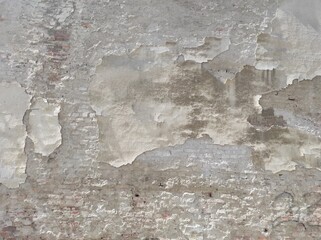 The texture of an old cracked plastered wall. Gray old wall. Rough texture