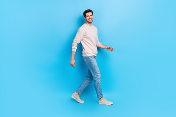 Full length photo of pleasant friendly guy dressed white pullover jeans shoes go at big sale empty...