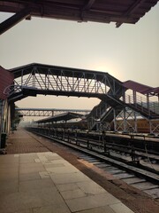 Train station with bridge and train.