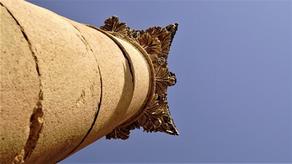 low angle of classic stone column against sky