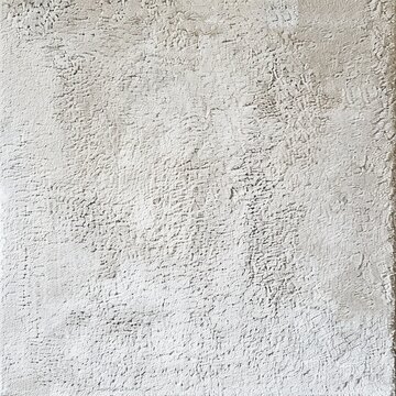 A close up of a white concrete wall with a rough texture.