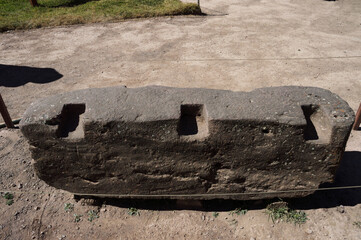 Stone cut in a rectangular shape with three cavities on top exposed at the archaeological site of Pisac - obrazy, fototapety, plakaty