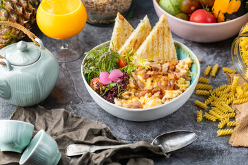 Bacon-infused scrambled eggs: Scrambled eggs cooked with crispy bacon pieces, offering a savory and...