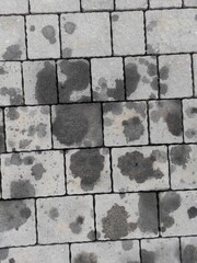 Black oil stains on the cobblestones. Error. Car service. Car breakdown