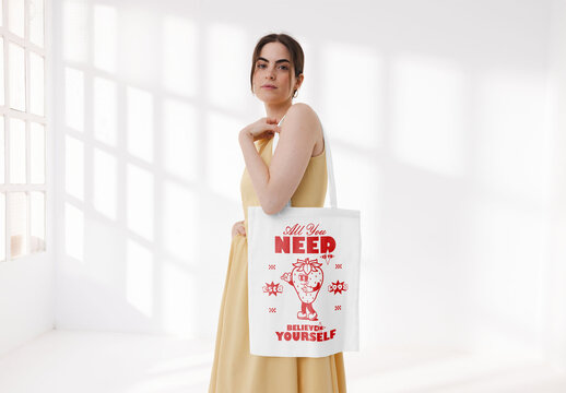 Mockup of woman holding customized tote bag in studio