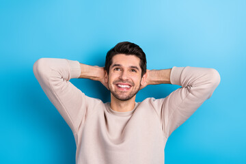 Photo of satisfied man dressed beige pullover arms behind head look empty space dream about...