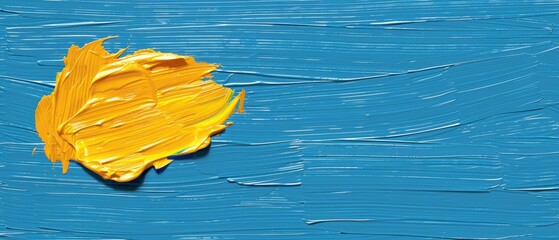   A yellow paint blob atop a blue paint spatula