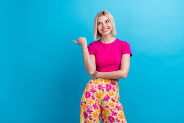 Photo portrait of lovely young lady point look empty space dressed stylish pink clothes isolated on blue color background
