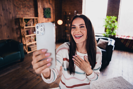 Photo of lovely young woman take selfie photo talk video call laugh wear striped outfit interior home living room in brown warm color