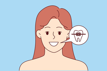 Woman with dental braces shows beautiful smile obtained thanks to trip to dentist or orthodontist. Girl recommends using dental braces and regularly visiting dentist clinic for prevent problems.