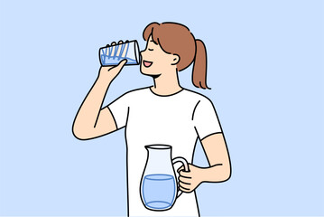 Woman drinks clean water from glass to refresh herself and saturate body with mineral aqua with vitamins. Girl with jug of water in hands, taking care of health, trying to avoid dehydration