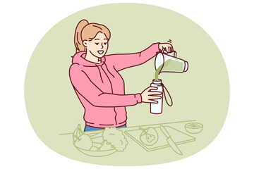 Woman using blender to make vegetable smoothie during detox diet or after morning run. Young vegan or vegetarian girl consumes cocktail of vegetables containing vitamins and nutrients for detox