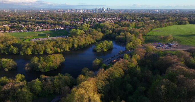 Heaton park lakes and the city of Manchester on the horizon during sunset time. 
