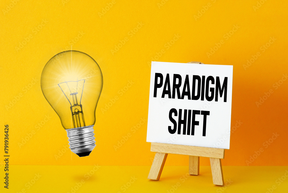 Poster Paradigm Shift is shown using the text and photo of light bulb