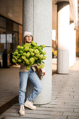 Voluminous bouquet of fresh flowers in a hands of girl in glasses - 791936671