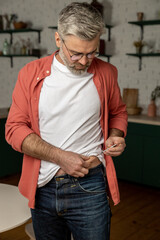 Man making medical diabetes insulin syringe injection into abdomen