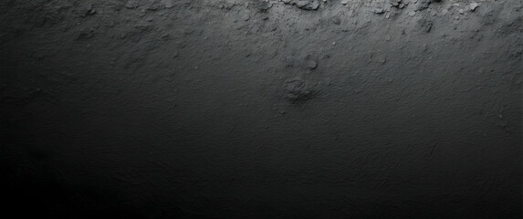 A detailed shot that showcases the textured surface of a black concrete wall suitable for a background with depth