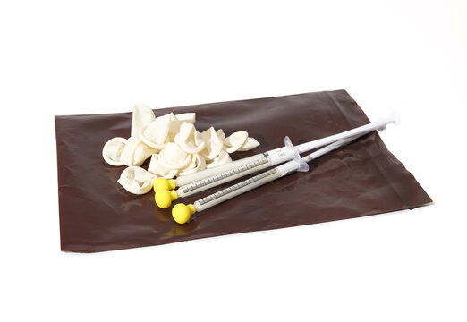 Home kit of transdermal gel in syringes, finger cots and protective bag. Prescription medication for cats and dogs. Gel is rubbed in animals ear. Veterinarian use or home care. Selective focus.