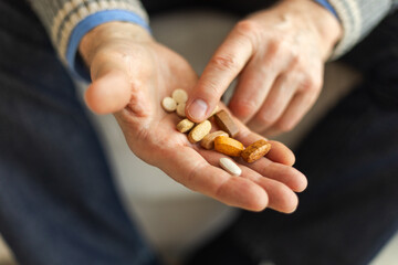 Hands with pills. Senior man hands holding medical pill. Mature old senior grandfather taking...