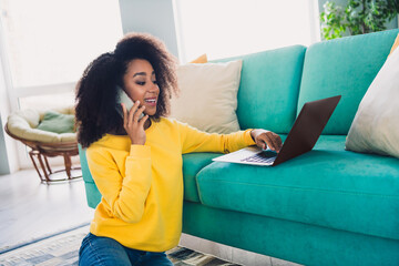 Photo of adorable cute girl working from comfortable home reading sms messgae sitting on floor room...