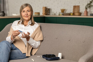 Mature blonde woman making home blood sugar test