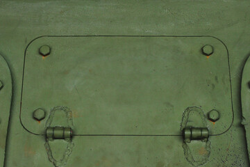 The surface of a tank with a closed hatch.