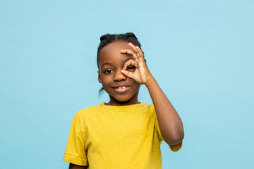 Smiling African American little boy showing okay gesture