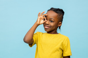 Funny African American little boy showing ok sign